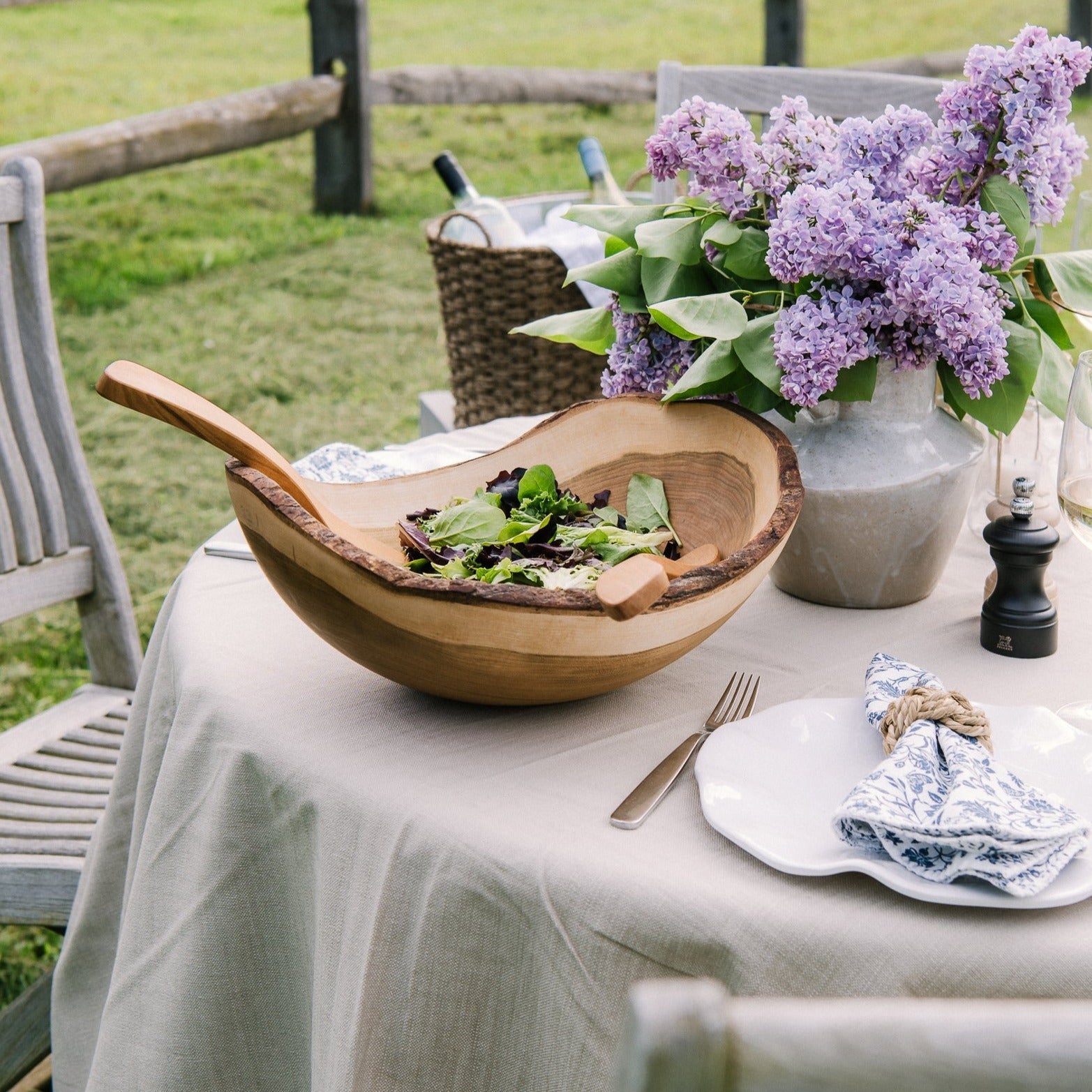 Rustic wood hand carved bowl on an outdoor table at Addison West