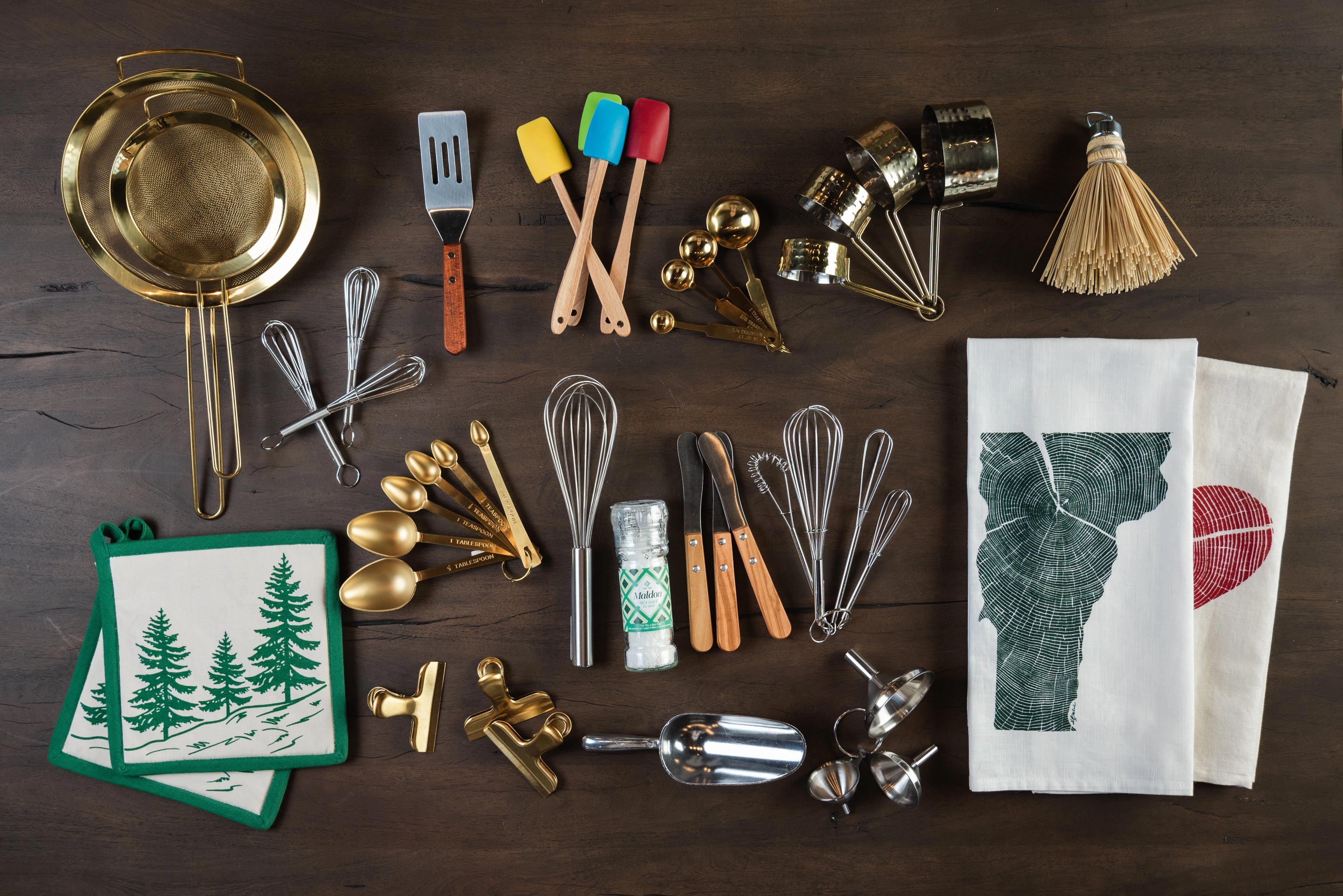 Gifts for the chef including mini spatulas, funnel set, gold measuring spoons, brass measuring spoons, copper measuring cups, brass strainer and tea towels at Addison West