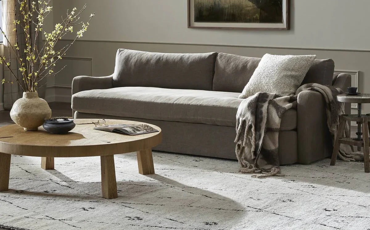 Amber Lewis x Four Hands sofa and a coffee table in a neutral living room at Addison West.