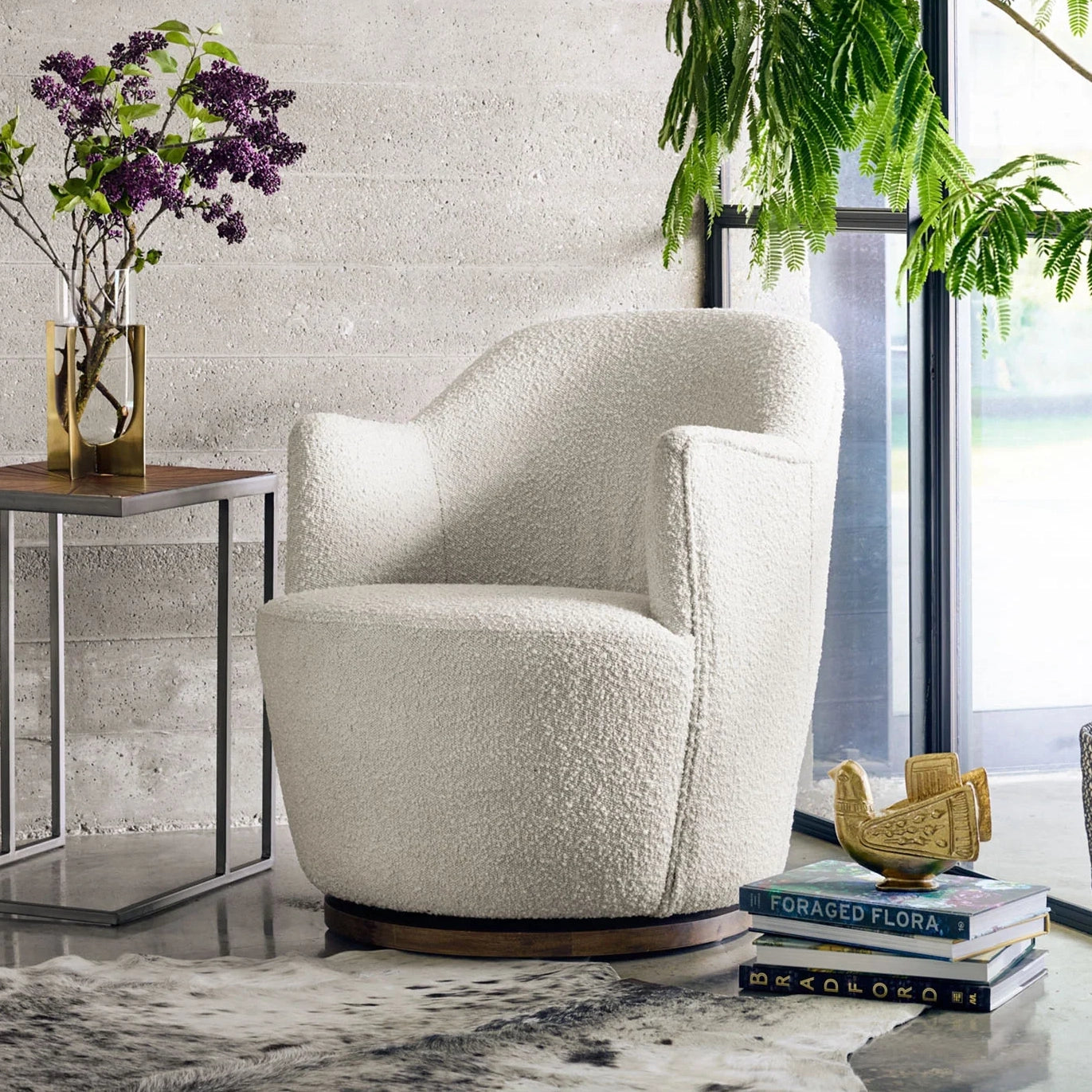 white boucle swivel arm chair next to a window at the Addison West