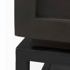 Square end table with black iron base, wood shelf and drawer and marble top on a white background