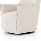 Light grey small swivel armchair by four hands furniture on a white background