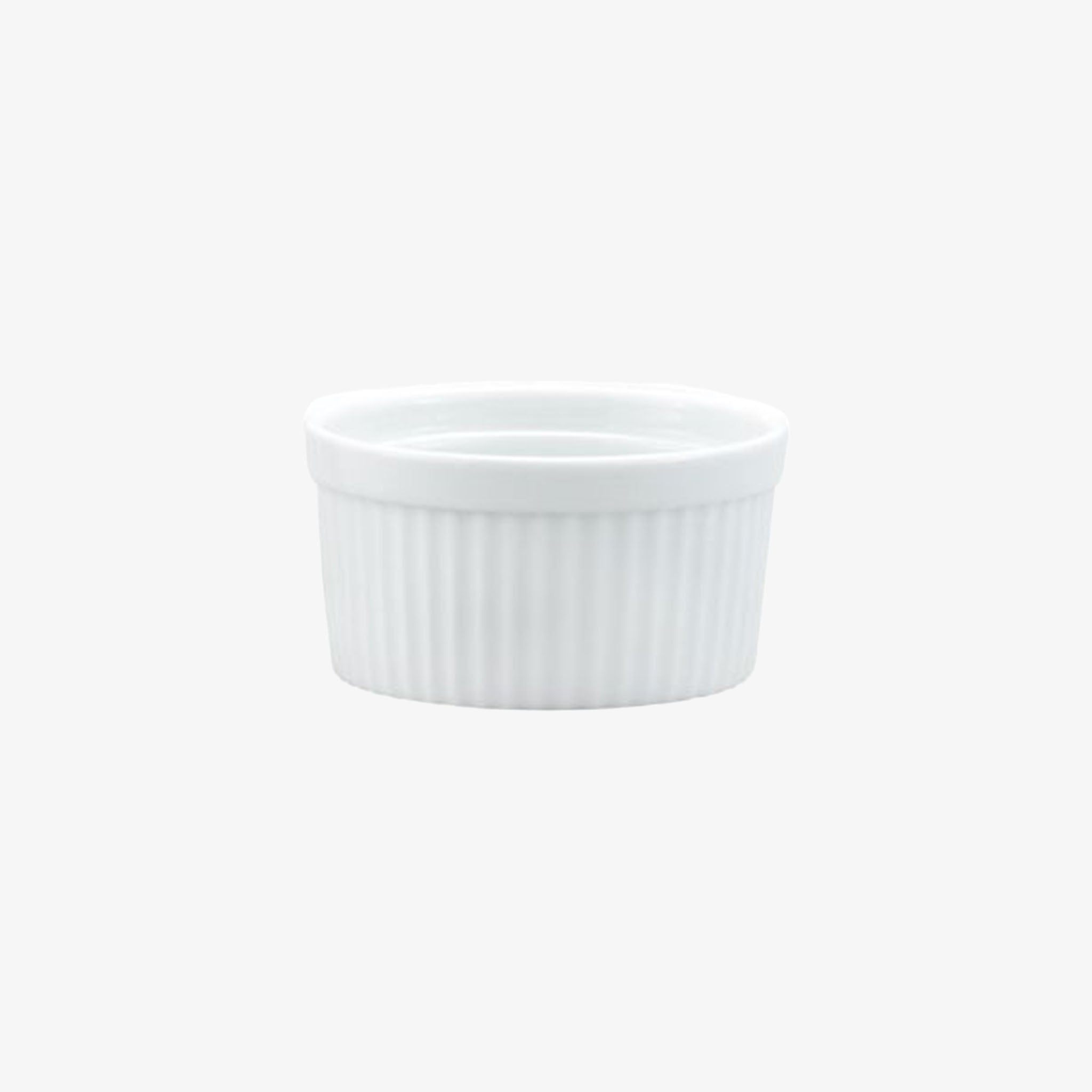 Small white ramekin with ridges on a white background