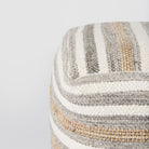 Close up of Aahana White/Taupe/Gray Striped Hemp and Cotton Pouf on a white background