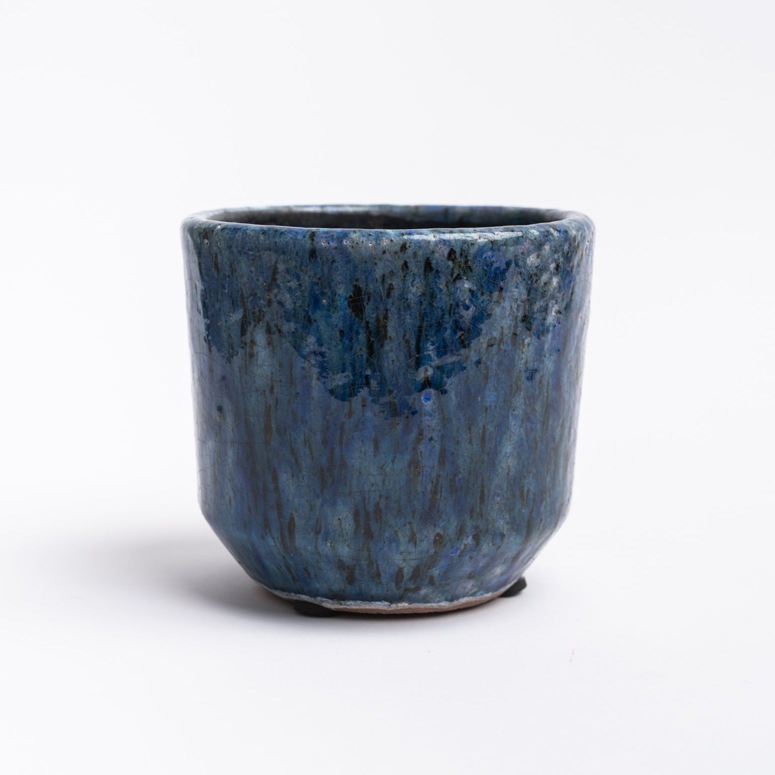 Indigo planter with reactive glaze on a white background