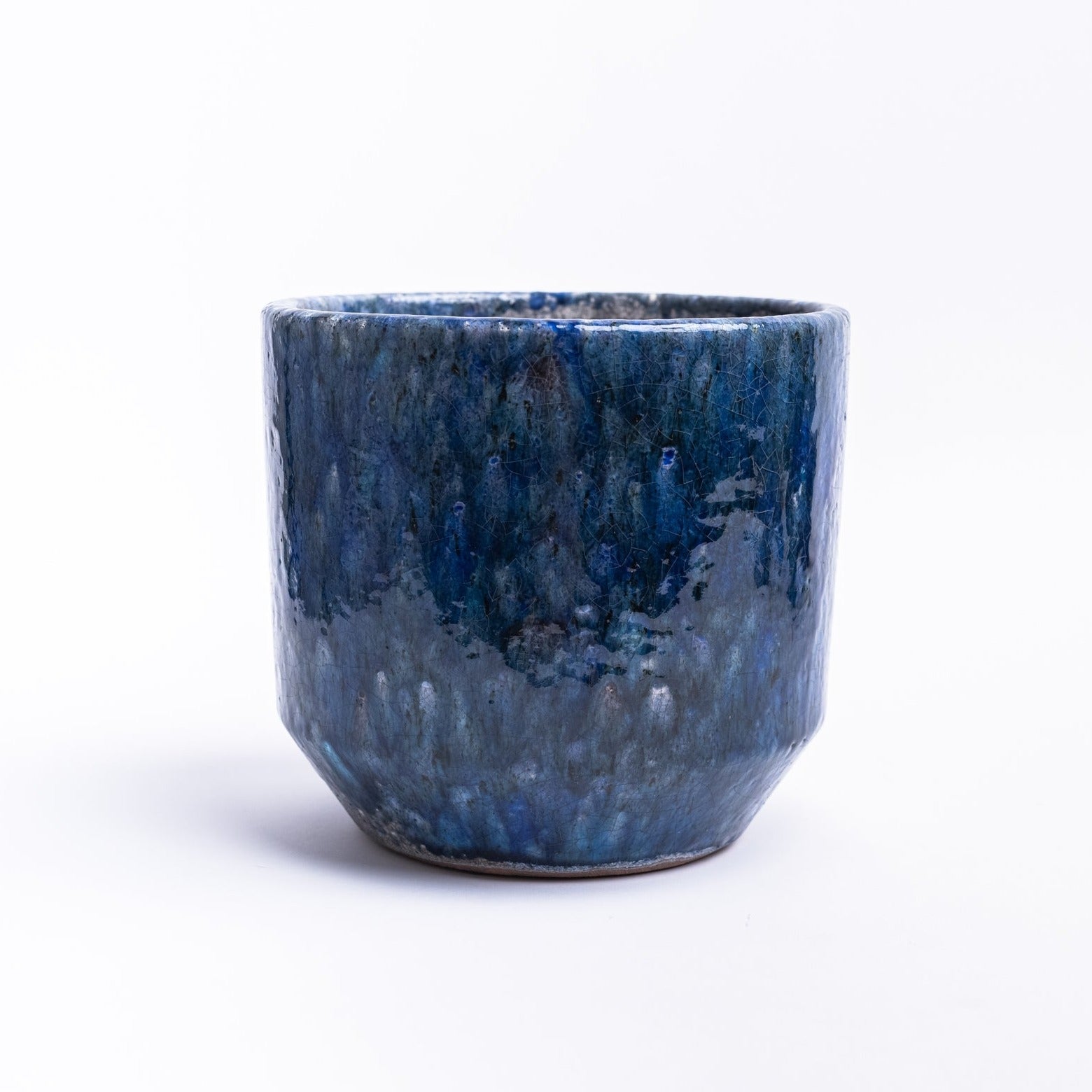 Small Indigo planter with reactive glaze on a white background