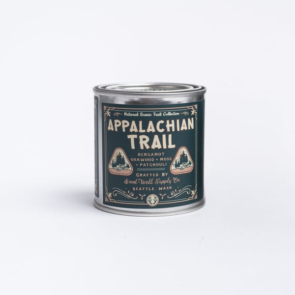 Appalachian trail bergamot oakwood moss patchouli candle in a tin on a white background