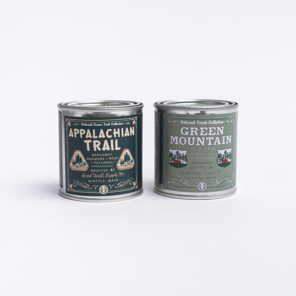 Appalachian trail candle and green mountain candle in tin on a white background