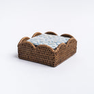 Dark stain scallop edge rattan cocktail napkin holder on a white background