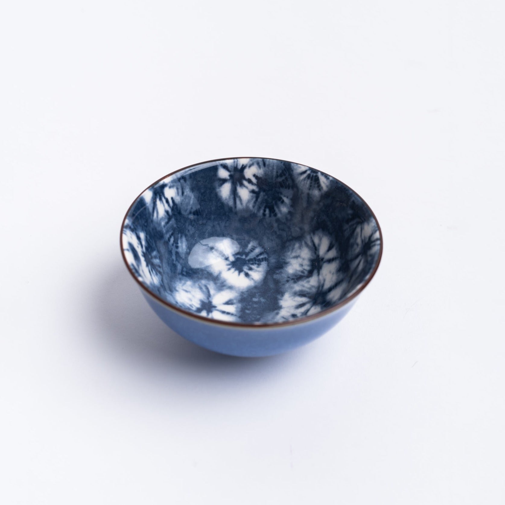 Small blue indigo bowl on a white background