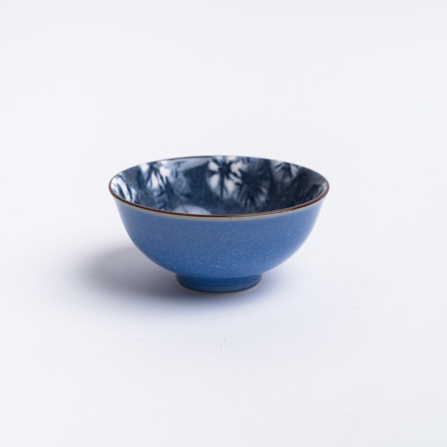 Small blue indigo bowl on a white background