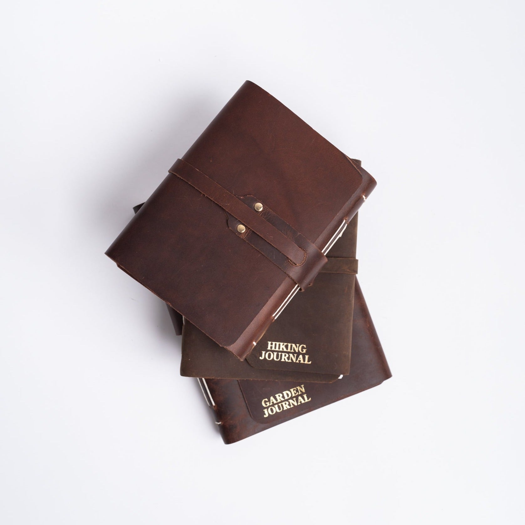 Handmade leather journals from above on white background