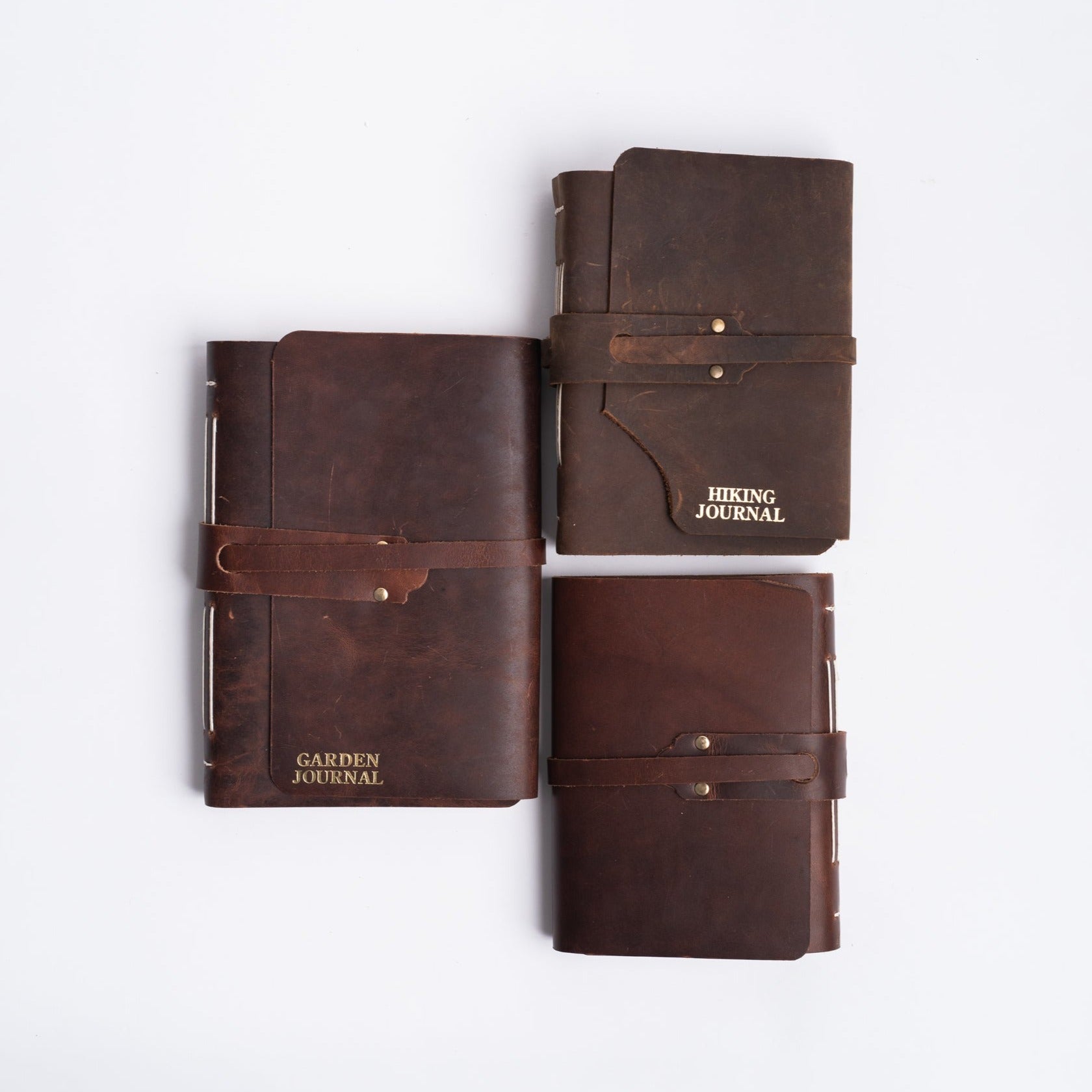 Handmade leather journals with strap on white background