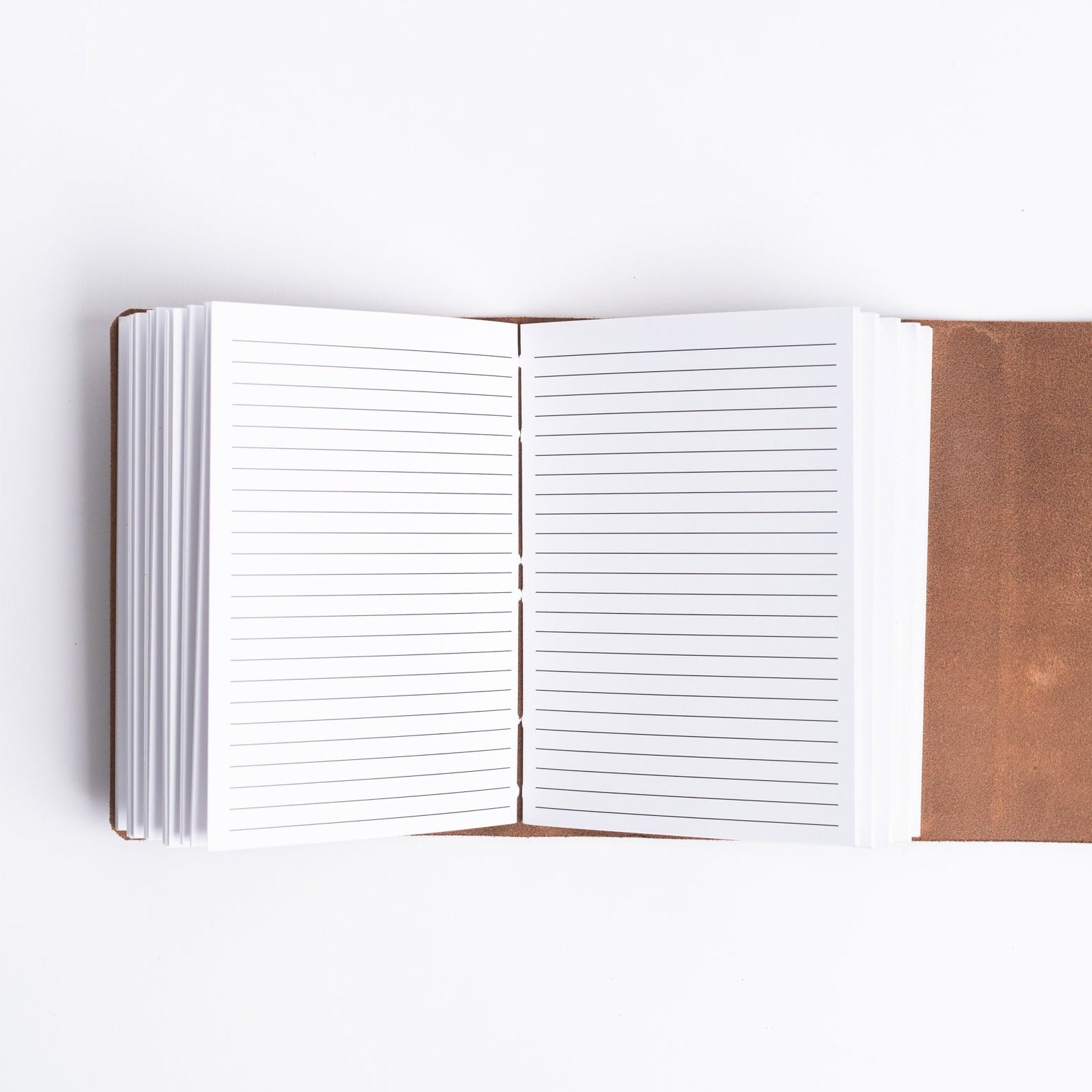 Vermont leather handmade journal from above with lined pages on a white background