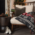 Ski VT Fair Isle Throw Blanket on a cozy chair in front of a holiday tree