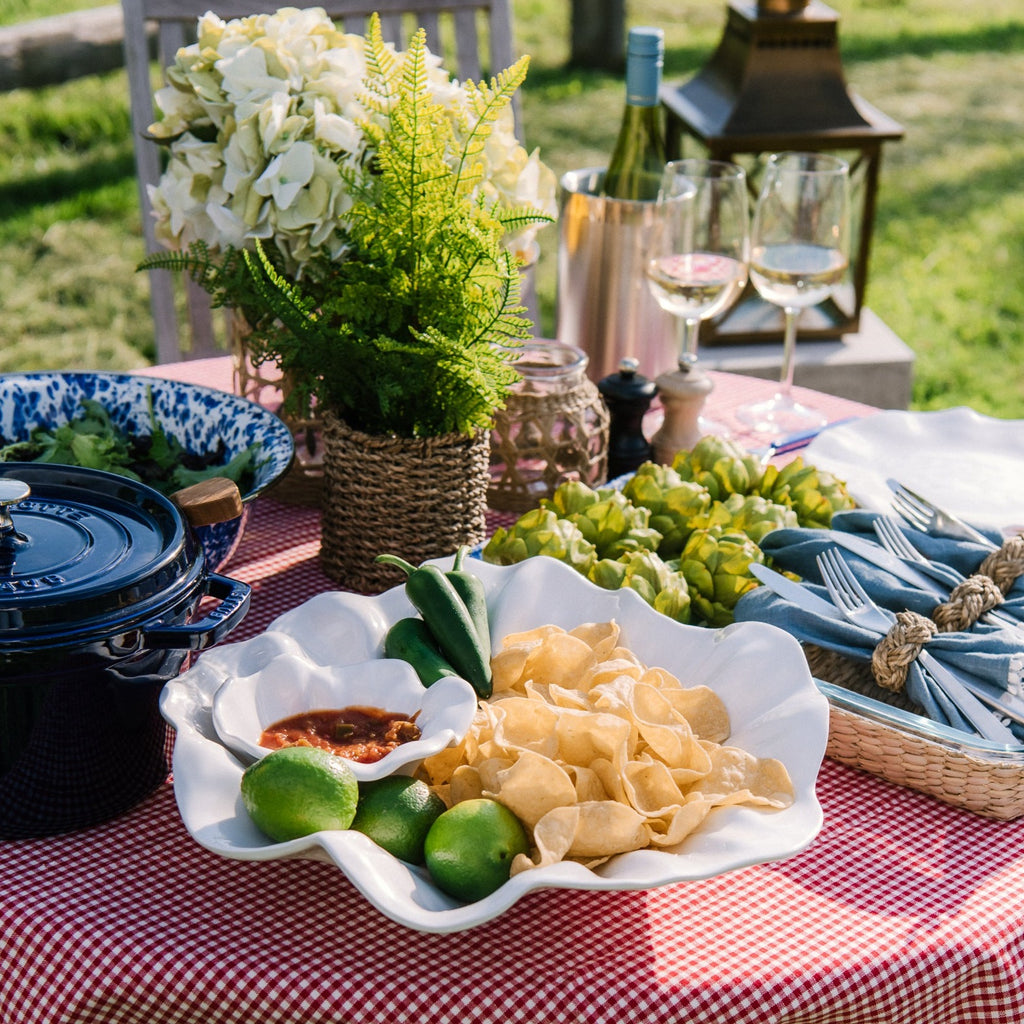 Beatriz Ball bloom chip and dip filled with chips and salsa on an outdoor dining table