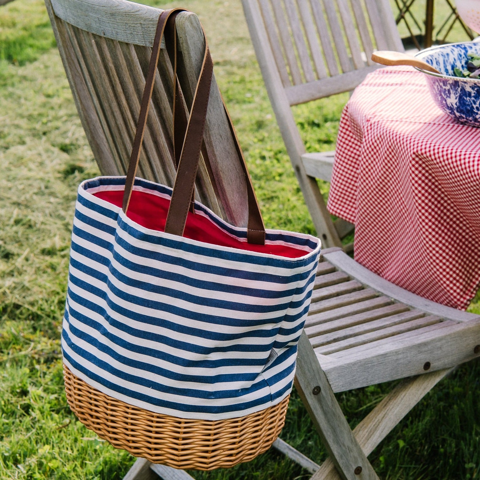 Coronado Canvas and Willow Basket Tote slung on the back of an outdoor dining chair