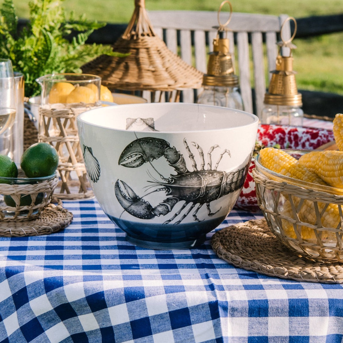 Laura Zindel Large Lobster Bowl on an outdoor dining table with a blue and white checked tablecloth