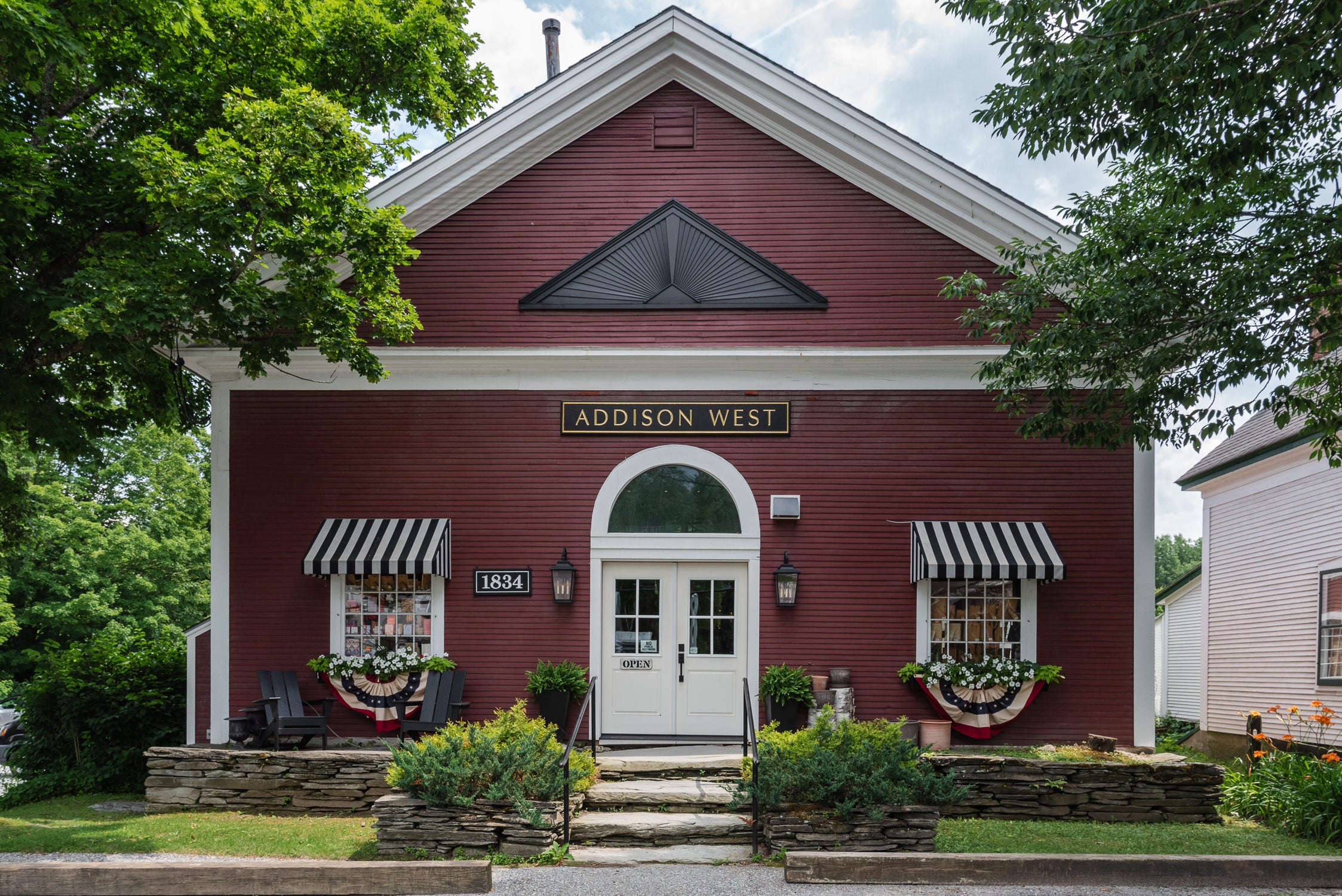 Addison West Waitsfield Vermont Home Goods, Furniture, Gift Store, and Interior Design Studio front of red building