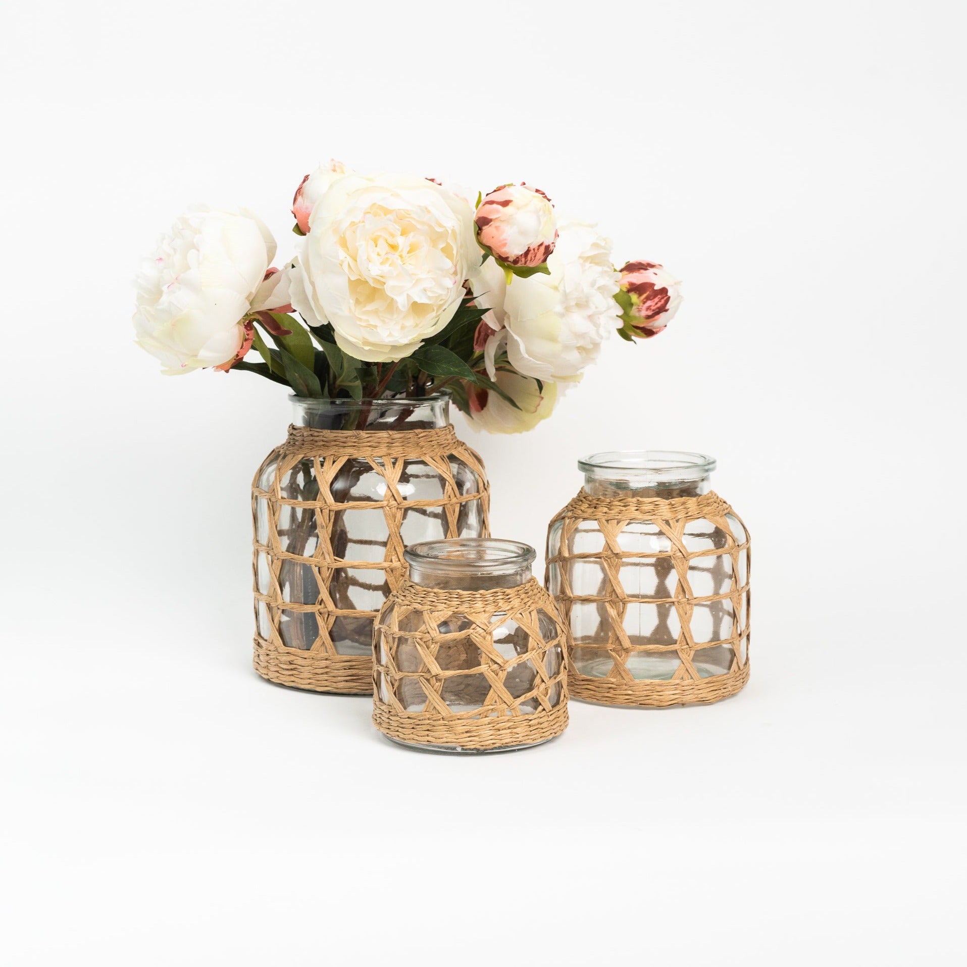 Seagrass Wrap Lattice Vases with flowers on a white background