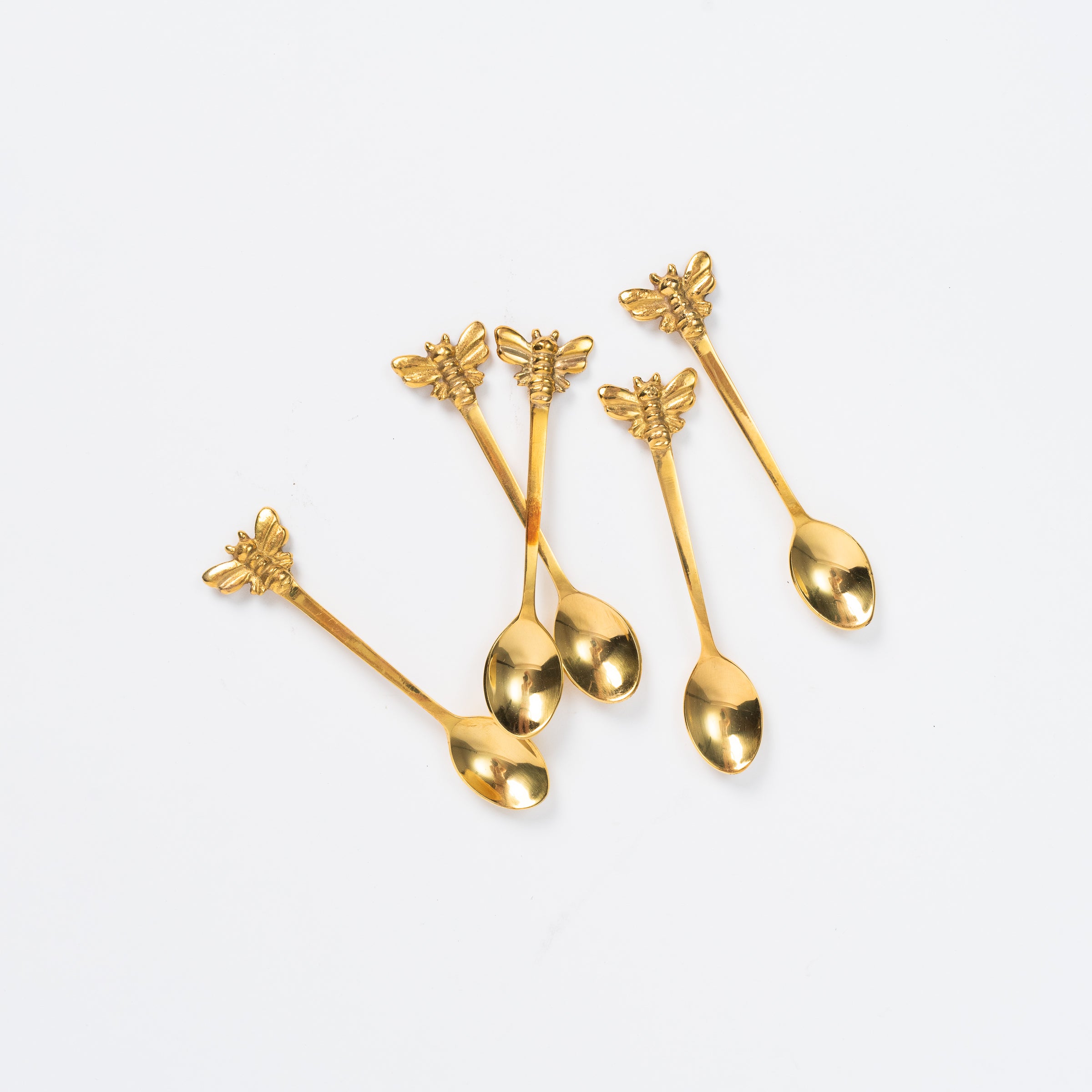 Bee Brass Spoons on a white background