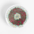 Liberty puzzles 'Pomegranate and Pinecone' wreath in a round box on a white background