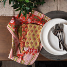 Vermont Handmade Napkins in Orange Chili Pepper on a dining table with plates and foliage