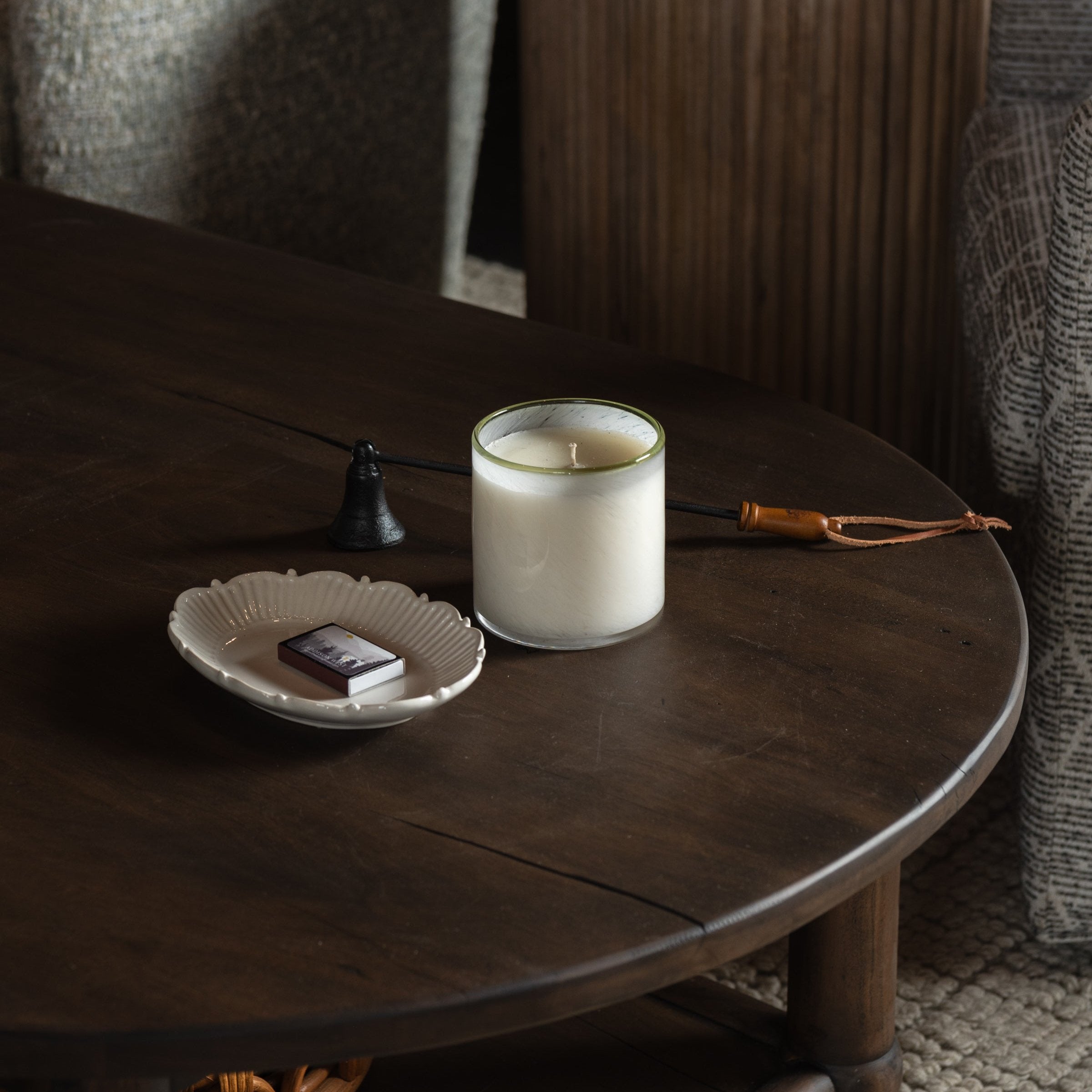 Lafco Feu De Bois 'Ski House' Signature Candle on a dark wood table at Addison West