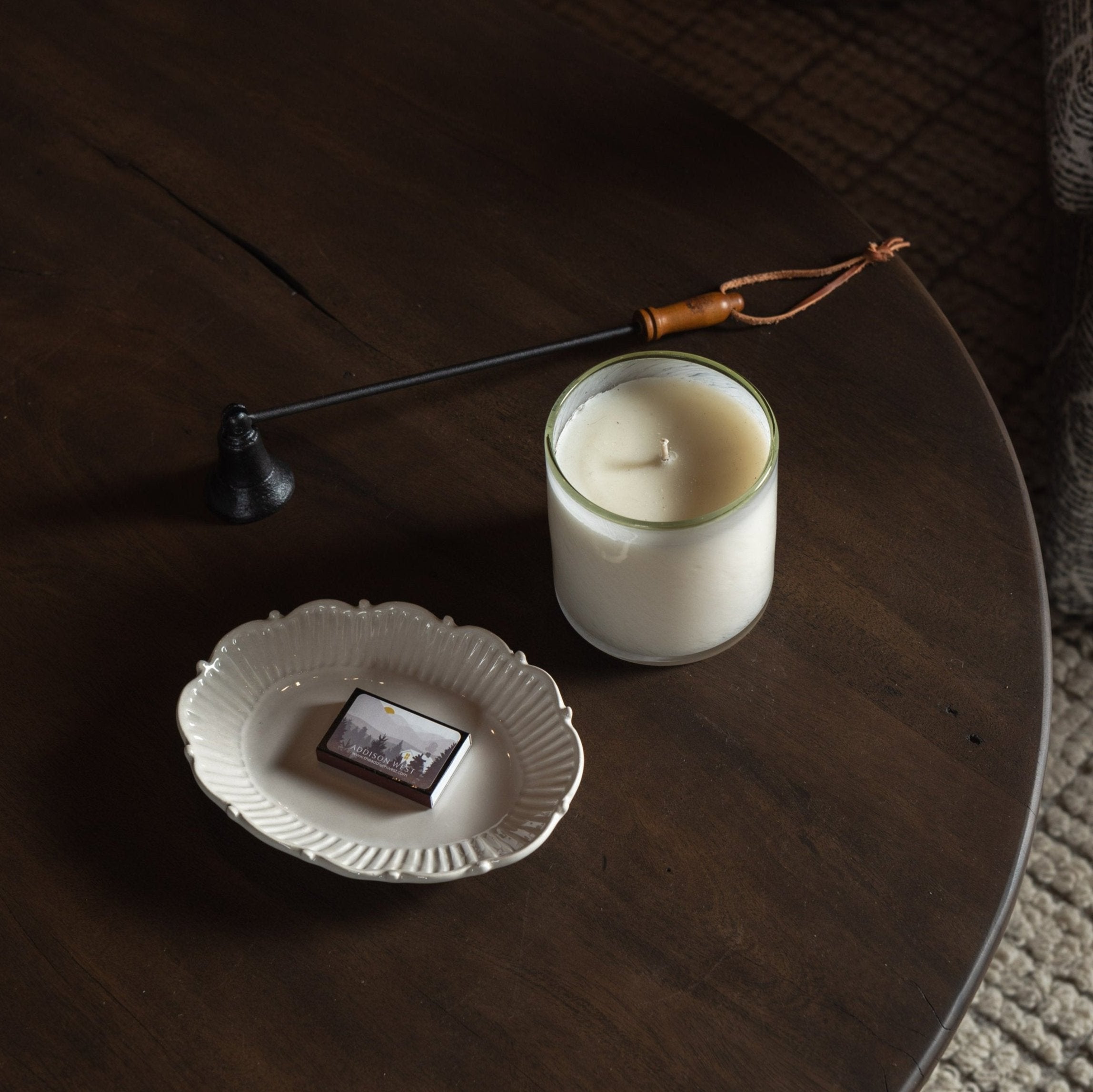 Lafco Feu De Bois 'Ski House' Signature Candle on a dark wood table at Addison West