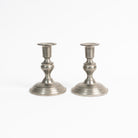 Vintage Pair Weighted Pewter Candlesticks on a white background at Addison West