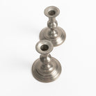 Vintage Pair Weighted Pewter Candlesticks on a white background at Addison West