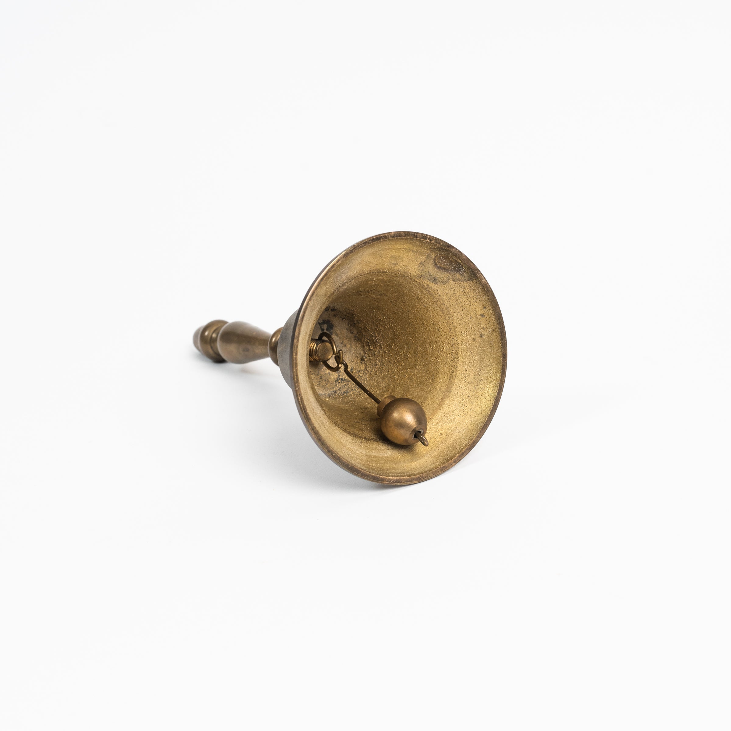 Vintage Brass Bell on a white background at Addison West