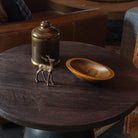 Vintage Brass Tobacco Tin vintage brass reindeer and vintage wood bowl on a dark wood table at Addison West