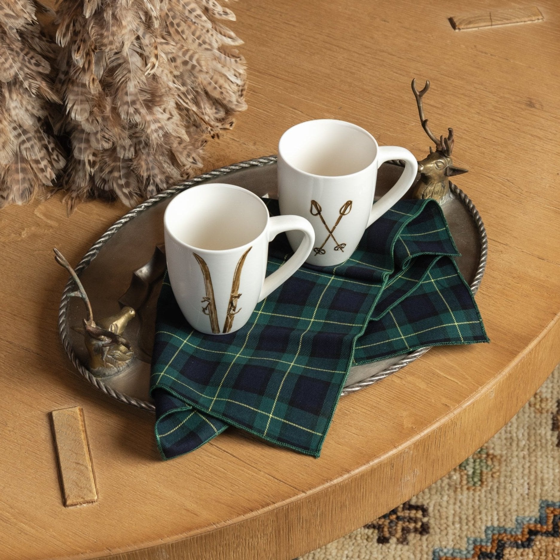 Vintage Pewter Deer Serving Tray and Ski Poles Mug and Forest Green Tartan Napkins on a coffee table with mugs at Addison West