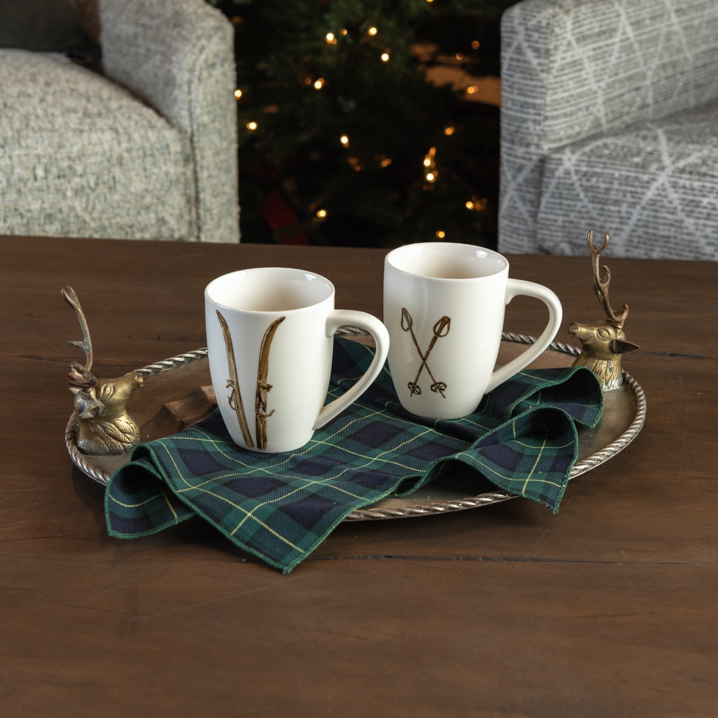 Vintage Pewter Deer Serving Tray and Ski Poles Mug and Forest Green Tartan Napkins on a coffee table with mugs at Addison West