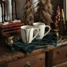 Vintage Pewter Deer Serving Tray and Ski Poles Mug and Forest Green Tartan Napkins on a table with mugs at Addison West