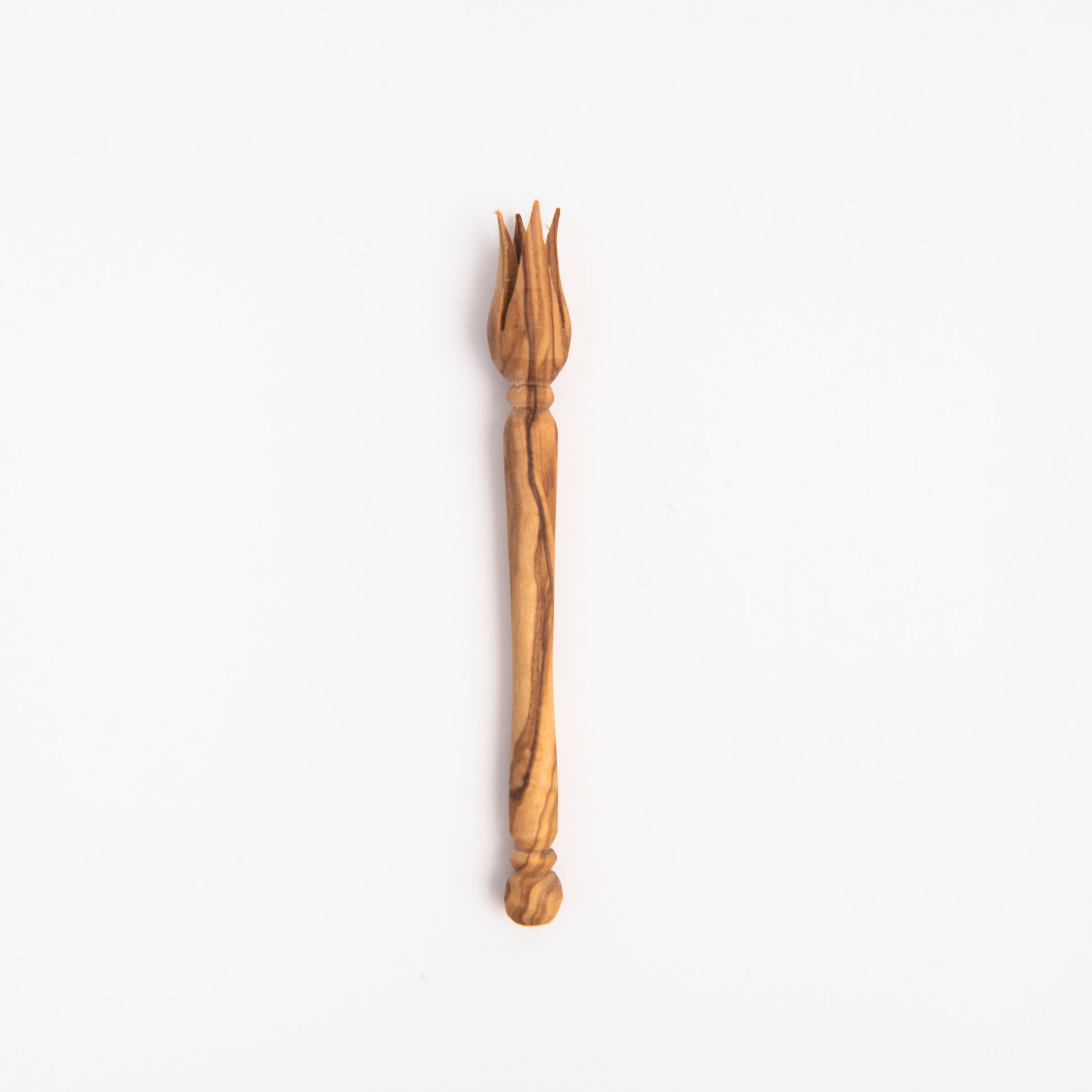 Olive Wood Olive Pick on a white background at Addison West