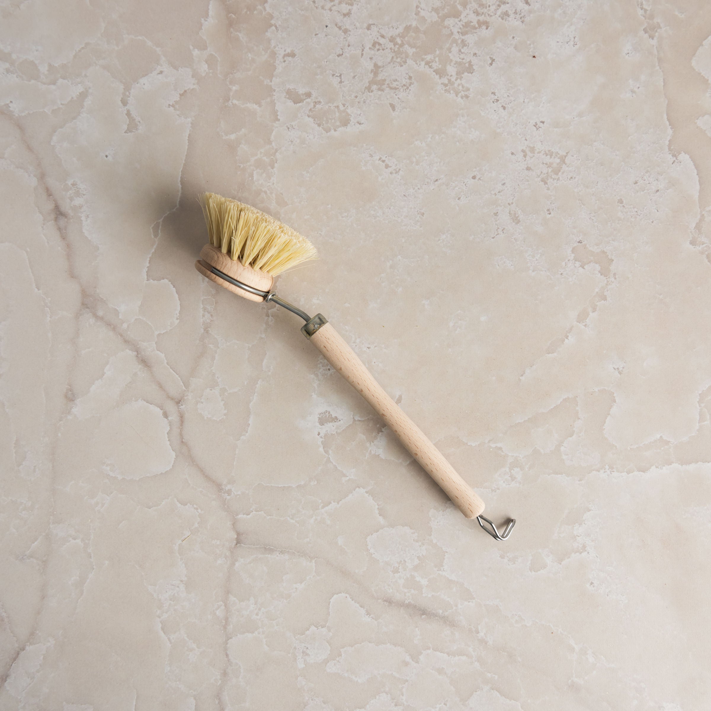 Redecker Natural Fiber Dish Brush on a marble table at Addison West