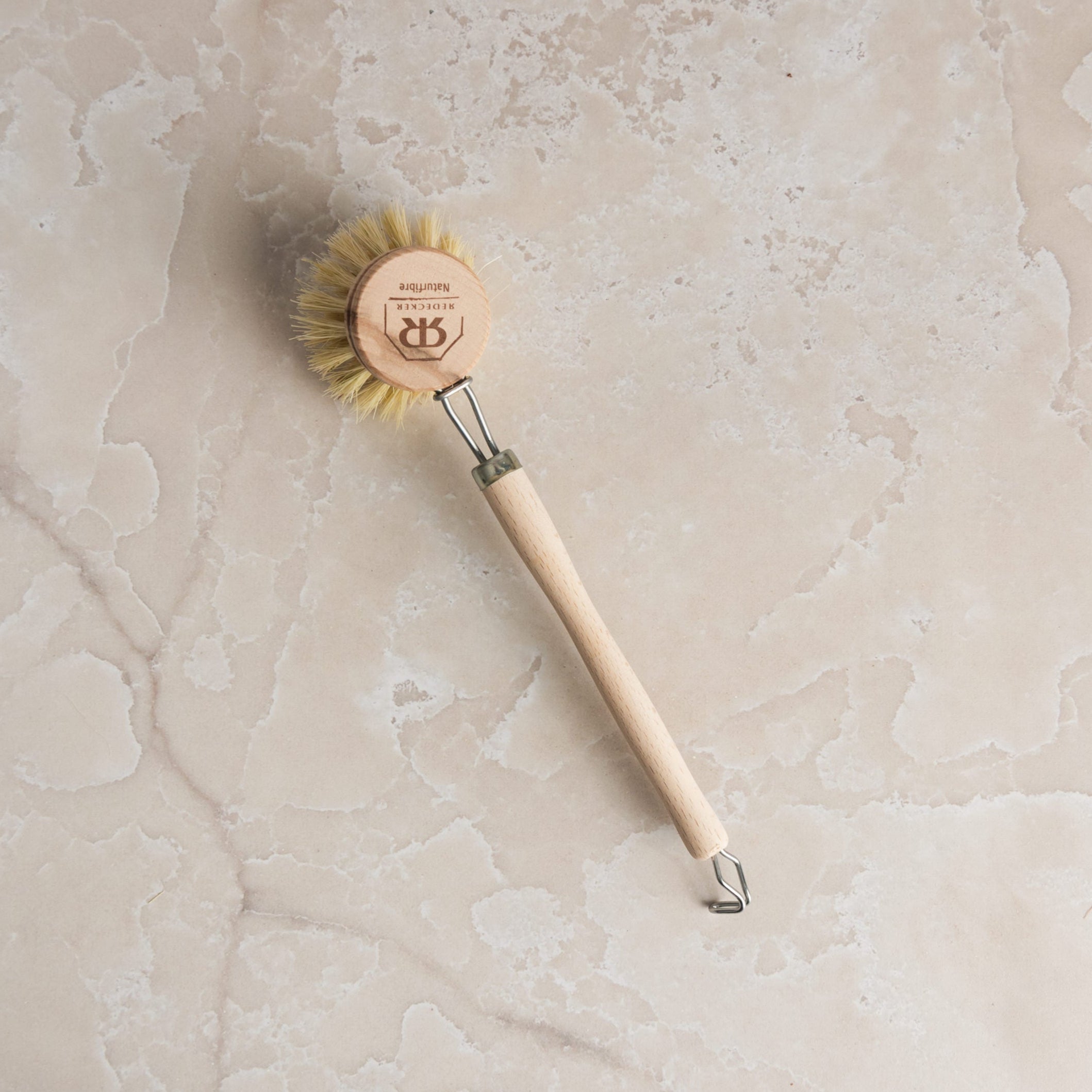 Redecker Natural Fiber Dish Brush on a marble table at Addison West