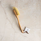 Classic Natural Dish Brush on a marble table at Addison West