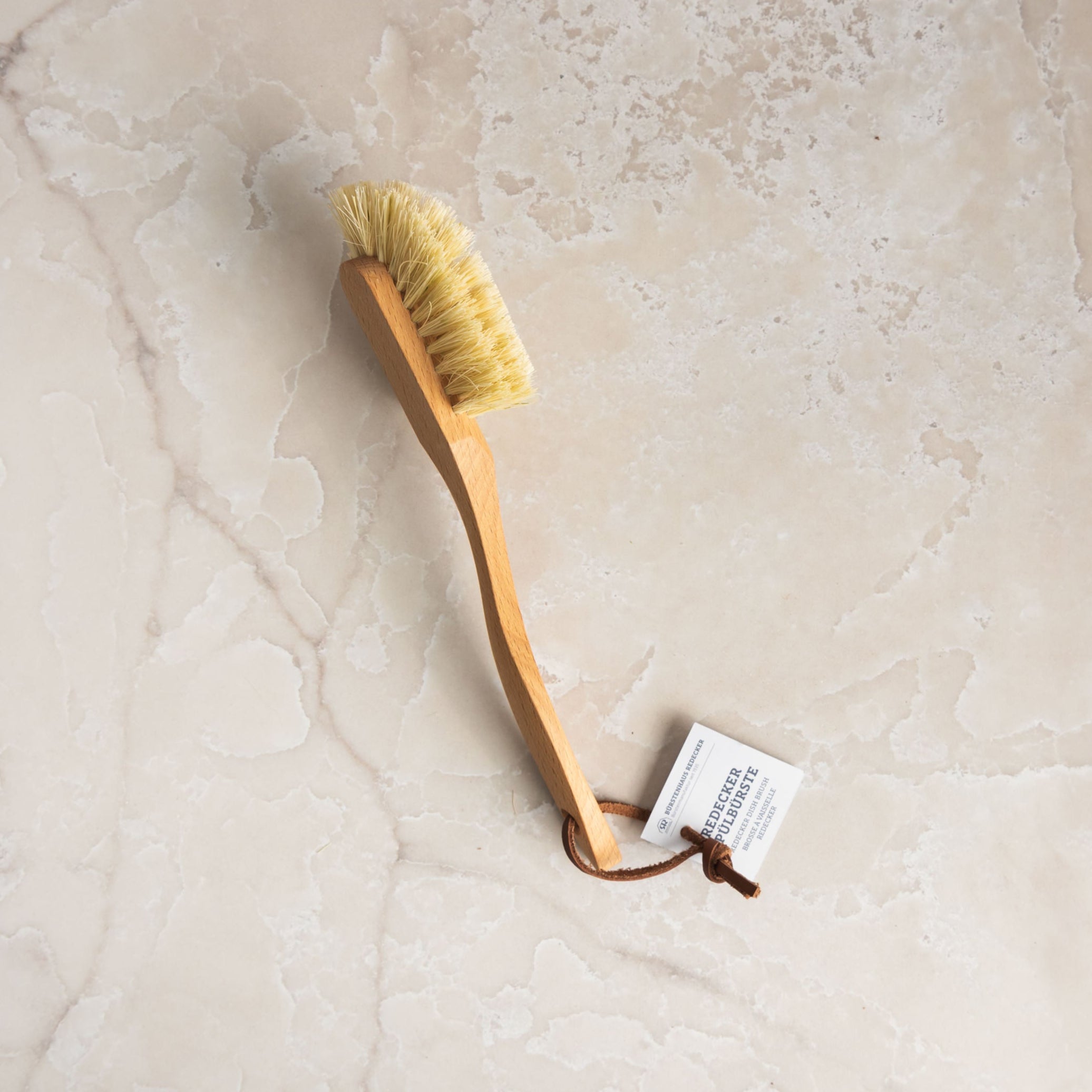 Classic Natural Dish Brush on a marble table at Addison West