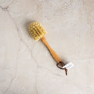 Classic Natural Dish Brush on a marble table at Addison West