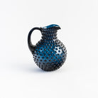 Night Blue Hobnail Pitcher on a white background at Addison West