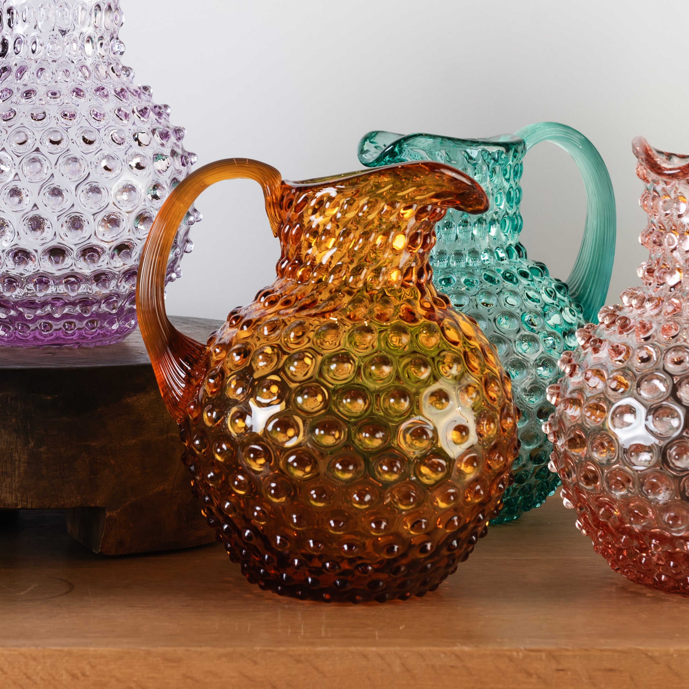 Amber Hobnail Pitcher on a wood table at Addison west