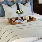 Madeira Double Sided Bed Blanket - Sky/Grey on a bed with a tray at Addison West