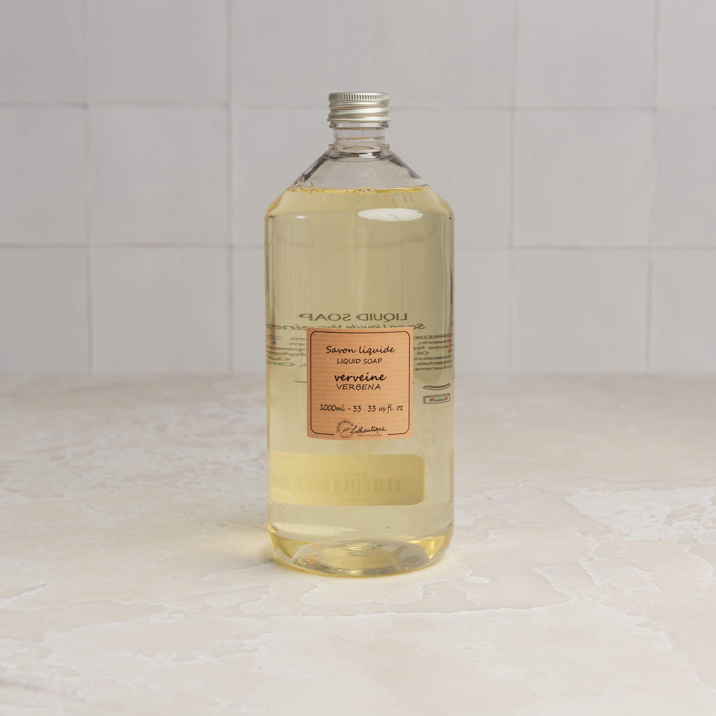 Lothantique 1L Liquid Soap Refill - Verbena on a marble table at Addison West