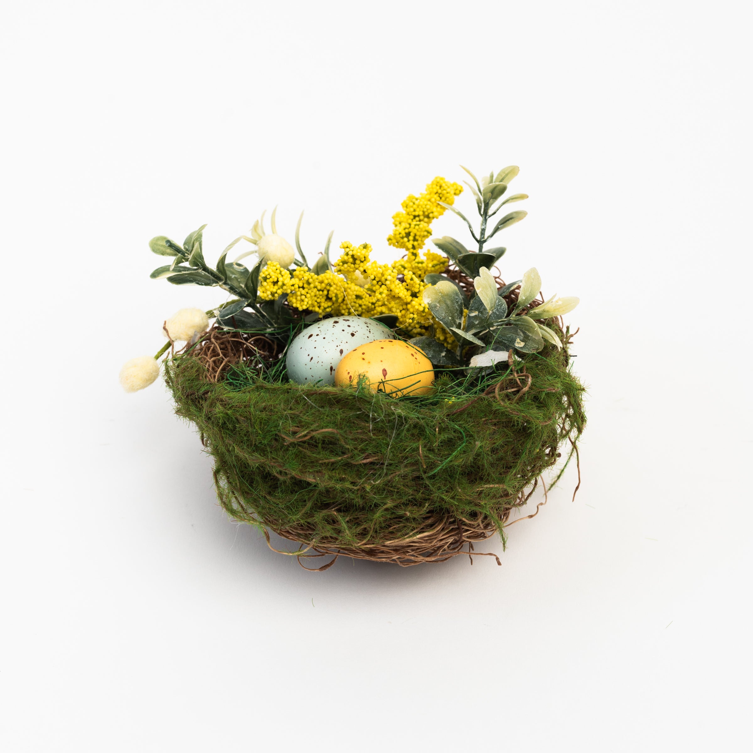 Easter Nest with Eggs and Faux Flowers on a white background at Addison West