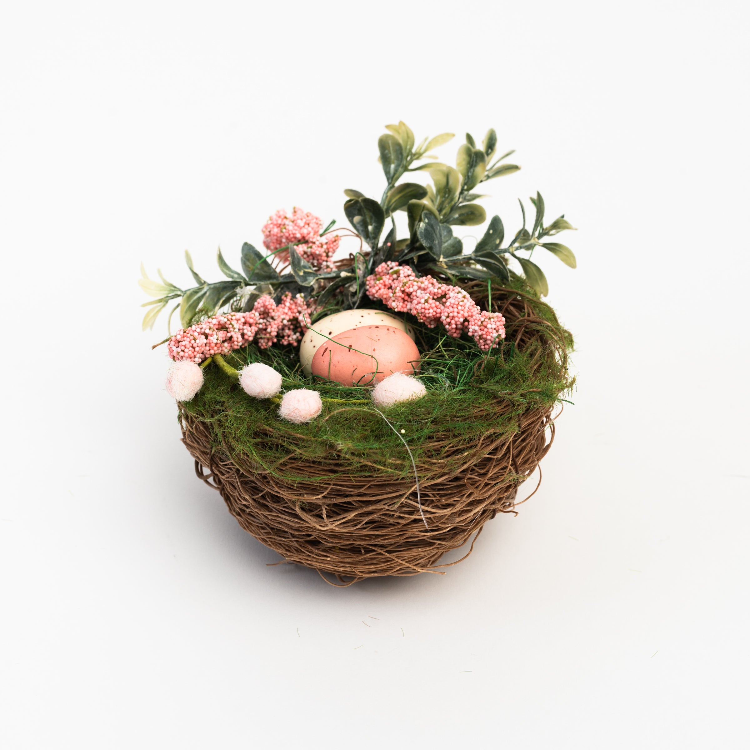 Easter Nest with Eggs and Faux Flowers on a white background at Addison West