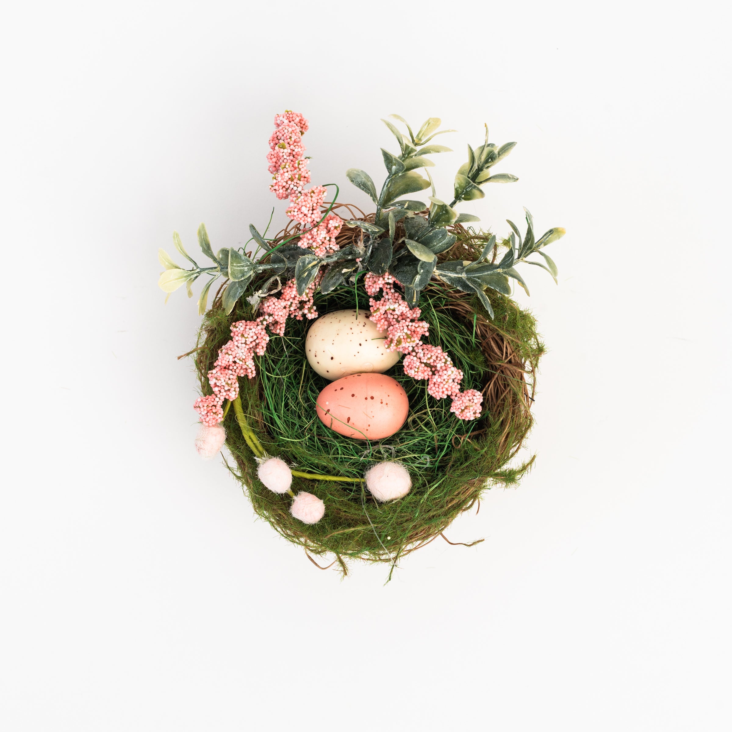 Easter Nest with Eggs and Faux Flowers on a white background at Addison West