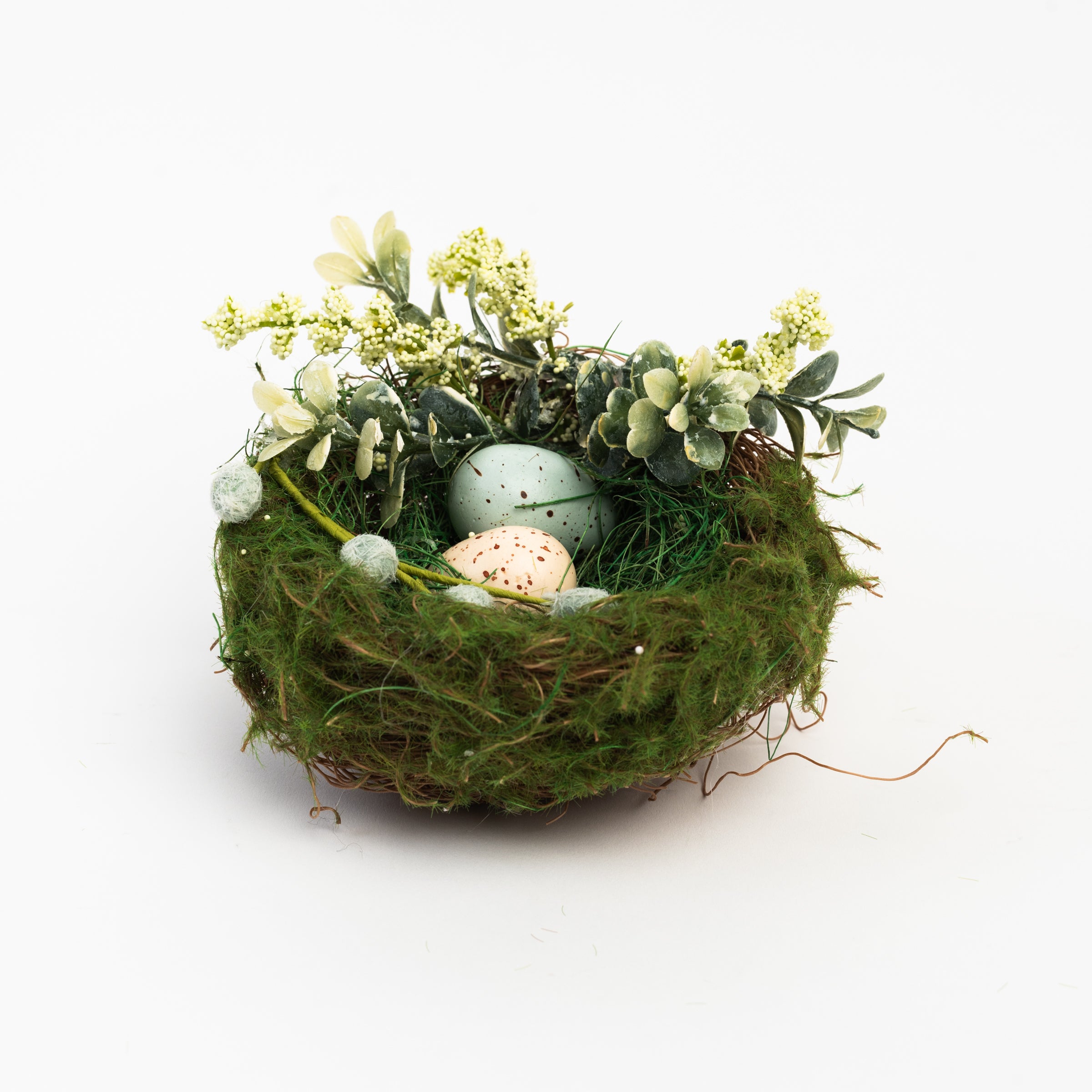 Easter Nest with Eggs and Faux Flowers on a white background at Addison West